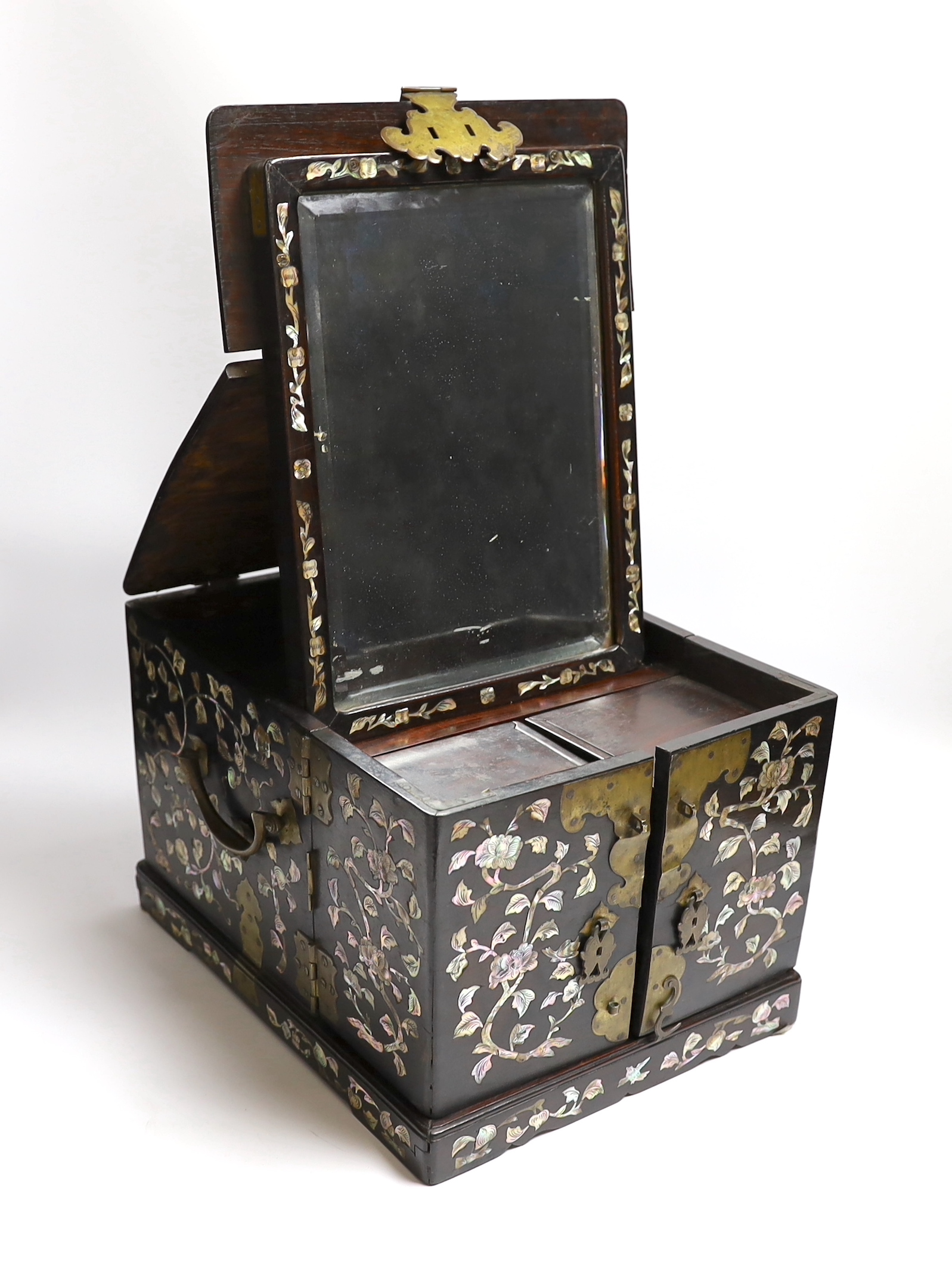 A Chinese mother-of- pearl inlaid hongmu vanity cabinet, late Qing dynasty, with fitted interior comprising a mirror, drawers, etc. 24cm x 31cm x 20cm